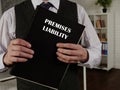 Lawyer holds PREMISES LIABILITY book. Premises liabilityÃÂ is the liability that a landowner or occupier has for certain torts that Royalty Free Stock Photo